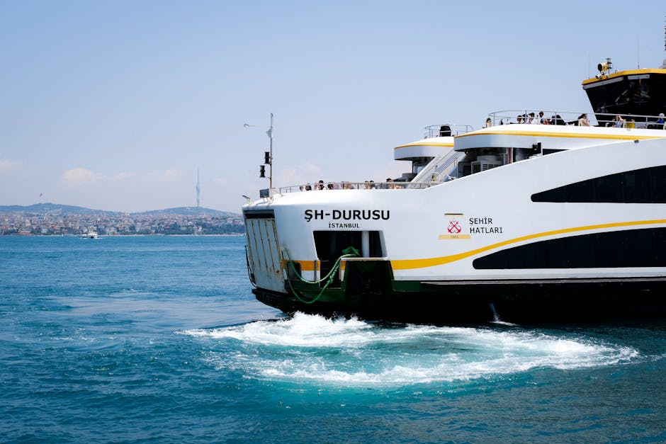 Ferry crossing the Bosphorus in Istanbul under a clear sky, offering a picturesque view.